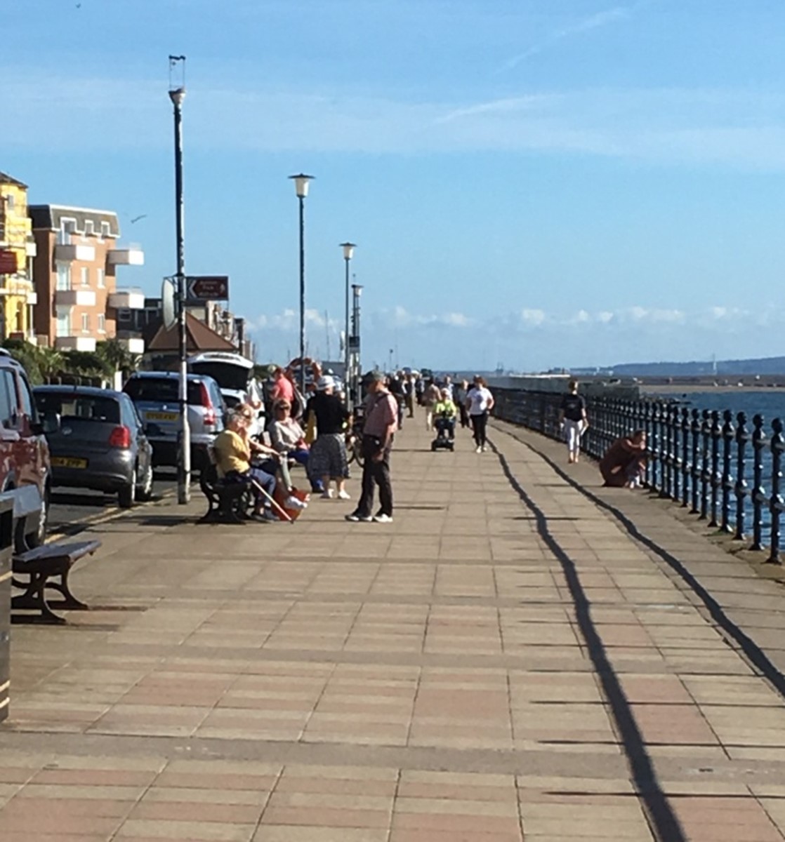 West Kirby promenade image showing people walking on a sunny day.